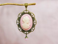 Cameo necklace with a large pink pendant, Selma Dreams Elegant Rose Gold Cameo Necklace, Cameo Round Pendant Necklace For Wedding, Wedding Necklaces With Cameo Round Pendant, Cameo Pendant Necklace For Wedding, Pink Cameo Necklace For Gifts, Elegant Oval Cameo Locket Necklace, Pink Medallion Necklace For Gifting, Vintage Pink Oval Pendant Jewelry, Elegant Cameo Locket Necklace For Wedding