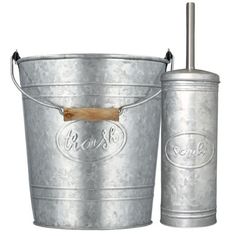 a metal bucket with a wooden handle next to it