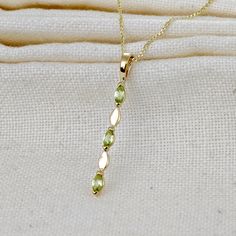 Elegant 9ct Gold marquise trilogy drop green peridot pendant. Ojewellery design and part of our first full gold collection. Produced in very small quantities you will only find this pendant from Ojewellery direct. The three natural green peridot are from Arizona USA. Each stone measures 4 x 2mm giving an approximately 0.23ct stone weight Peridot are associated with harmony, peace and compassion. They are the birthstone for August. This elegant pendant is suitable to wear for daytime or evening w Uk Design, Peridot Pendant, Arizona Usa, Elegant Pendant, Green Peridot, Gold Collection, Jewelry Packaging, Metal Stamping, Chain Styles