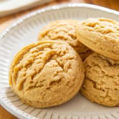 three peanut butter cookies on a white plate