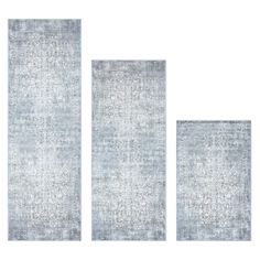 three rugs with different shapes and sizes on the same floor, one in grey