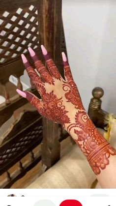 a woman's hand with henna on it