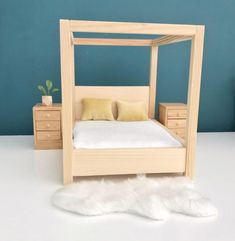 a bed made out of wood with white fur on the floor and blue wall behind it