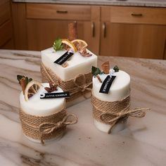 three candles are wrapped in jute and tied with twine on a kitchen counter