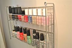 a metal shelf with many different types of nail polishes and other items on it