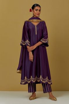 Purple kurta with floral embroidery and V neck. Paired with sequin work pant and tissue organza fringe dupatta. Components:3 Pattern:Embroidered Type of Work:Floral Neckline:V Neck Sleeve Type:Flared Fabric:Chanderi Silk, Tissue Organza Color:Purple Other Details: Floral and sequin work Occasion:Puja - Aza Fashions Cotton Silk Palazzo Set With Gota Work, Designer Anarkali Sharara With Embroidered Border, Bollywood Style Unstitched Slub Silk Suit With Gota Work, Semi-stitched Gota Work Sets With Traditional Drape, Eid Kurta With Embroidered Border In Chinon, Bollywood Style Festive Cotton Silk Sharara, Elegant Raw Silk Salwar Kameez With Embroidered Border, Embroidered Raw Silk Palazzo Set With Traditional Drape, Designer Wear Sets With Gota Work In Traditional Drape