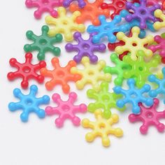 small multicolored plastic snowflakes on a white surface