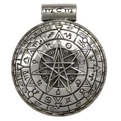 an image of a silver pentagramil with symbols on it's back side