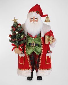 a santa clause figurine holding a small christmas tree and presents in his hand