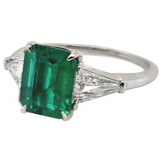 Breathtaking handmade emerald and diamond engagement ring. Set in platinum. Centered with an AGL (American Gemological Laboratories) certified natural emerald-cut emerald that weighs 1.60 carats. This magnificent deep saturated color is natural to the Emerald. The AGL report states there is no gemological evidence of heat. The center emerald is accentuated by two matched custom 'Baguette' Cut diamonds that weigh approximately 0.72 carats total. Accompanied with individual GIA (Gemological Institute of America) reports with graded G color with VS1-VS2 clarity. This beautiful ring is currently size 6, and it can easily be custom sized. An elegant classic piece of jewelry. Alice Kwartler has sold the finest antique gold and diamond jewelry and silver for over forty years. Emerald And Diamond Ring, Emerald Rings, Platinum Diamond Rings, Emerald Diamond Ring, Emerald Engagement, Green With Envy, Emerald Engagement Ring, Three Stone Rings, Shiny Things