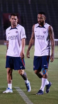 two soccer players are standing on the field