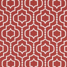 a red rug with white geometric designs on it