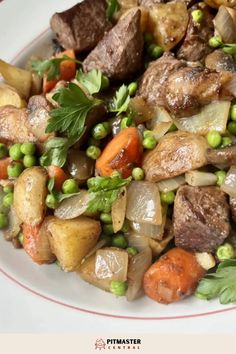 a white plate topped with meat and vegetables