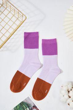 Materials: 80% Combed Cotton, 15% Polyamide, 5% Elastane. Size: Medium US Shoe Size Women 5-10 / Men 5-8.5 Thickness: Medium Weight: 1.5 oz These socks feature a trendy and playful color-blocking design with a soft ribbed texture that provides both comfort and style. Each pair combines two complementary or contrasting colors, creating a bold statement that elevates any outfit. Made from a soft, breathable fabric blend, these socks offer a snug fit perfect for daily wear, whether you're lounging Casual Brown Stretch Socks, Comfortable Solid Color No-show Socks, Casual Brown Mid-calf Socks, Purple Cotton Socks For Winter, Cozy Warm Multicolor Socks, Sporty Multicolor Cotton Socks, Purple Cotton Winter Socks, Casual Multicolor One-size Socks, Playful Multicolor Cotton Socks