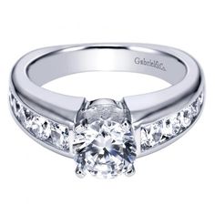 a white gold engagement ring with channel set diamonds