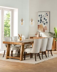 a dining room table surrounded by chairs and plants