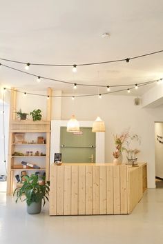 the interior of an office with plants and lights