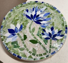 a plate with blue and green flowers on it