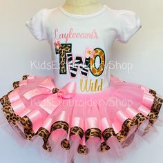 a white shirt and pink tutu skirt with leopard print on the bottom, two o'clock wild