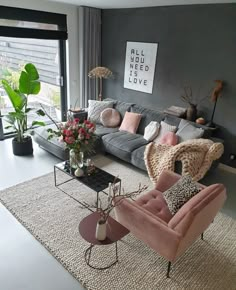 a living room filled with furniture and lots of windows