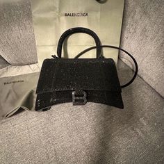 Nwt$6,850 Balenciaga Hourglass Xs Black Crossbody Handbag In Black Rhinestone Best Offers Are Accepted Hourglass Xs Handbag Straight From Berdof Goodman Receipt Included Suede Calfskin And Rhinestones Handbag Curvilinear Base One Handle Studded Magnet Closure B Logo Hardware With Rhinestones 1 Back Pocket 1 Inner Patch Pocket Nappa Lambskin Lining Wipe With A Soft Cloth Made In Italy Size 7.4''W X 5.1''H X 3.1''D Adjustable And Removable Crossbody Strap, 21.6'' Designer Top Handle Shoulder Bag For Events, Black Luxury Shoulder Bag For Events, Luxury Black Shoulder Bag For Events, Luxury Handheld Evening Bag With Dust Bag, Luxury Crossbody Party Bag, Designer Handheld Evening Shoulder Bag, High-end Shoulder Bag With Branded Hardware For Parties, Designer Handheld Shoulder Bag For Evening, Modern Shoulder Bag With Branded Hardware For Party