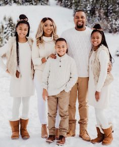 a family posing for a photo in the snow