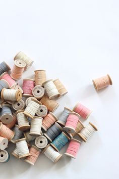 many spools of thread on a white surface