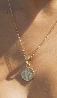 A reversible pendant and replica of an ancient Greek coin. A boy and dolphine on one side, and a horseman on the other. Size of pendant: 19mm and .75" round Length of pendant: 1 3.8" About Alchemia -Alchemia is a special blend of base metals used to produce matchless pieces with the look and feel of 18K gold. Alchemia does not contain nickel, lead, or cadmium. The special attributes of Alchemia make it very fascinating because it carries the quality and aesthetics of gold with a price that doesn Mythological Engraved Round Pendant Jewelry, Ancient Style Medallion Coin Pendant Jewelry, Mythological Style Gold Coin Pendant Jewelry, Gold Mythological Coin Pendant Jewelry, Gold Mythological Jewelry With Coin Pendant, 14k Gold Round Pendant Amulet Coin Necklace, Ancient Yellow Gold Coin Pendant Jewelry, Engraved Ancient Coin Necklace, Symbolic Coin Necklace With Locket Round Pendant