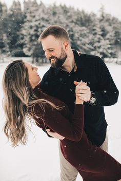 a man and woman dancing in the snow