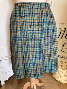 "Vintage Retro Wool Tartan Herringbone Pleated Skirt Medium 12/14 60s/70s Blue Yellow Waist 30\" Hips up to 40\" Length 24\" top of waistband to hem. It is shown on a size 12 mannequin 36/26/37\"  Side Zip fastening with 2 hook and eyes to waistband. This could enable the waistband to be worn slightly larger. Well made with two pleats to front and back. Label says 30 and is by Debenette as own brand Debenhams design. All items are vintage and may show some signs of wear commensurate with age. Pl Vintage Blue Pleated Skirt, Vintage Blue Pleated Skirt Bottoms, Vintage Blue Full Skirt, Retro Blue Pleated Skirt, Retro Blue Lined Skirt Bottoms, Retro Blue Lined Skirt, Retro Blue Full Skirt, Vintage Multicolor Skirt For Fall, Blue Lined Vintage Skirt