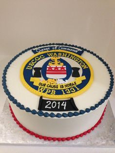 a cake is decorated with an emblem and name