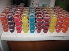 there are many cups that have colored liquids in them