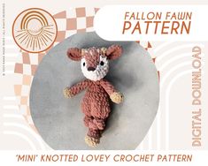 a knitted teddy bear laying on top of a white and orange checkered background