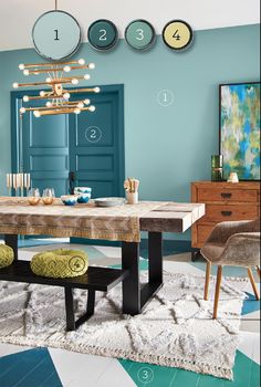 a dining room table with two chairs and a chandelier hanging from the ceiling