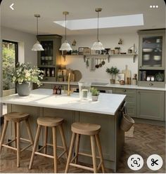 an image of a kitchen setting with stools and counter tops in front of the island