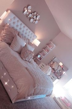 a white bed sitting in a bedroom on top of a carpeted floor next to a window