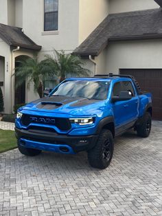 a blue truck parked in front of a house