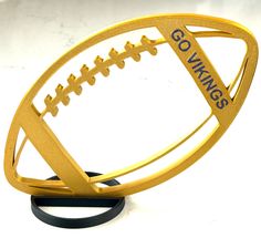 a gold football trophy with the words gowings on it's front and side