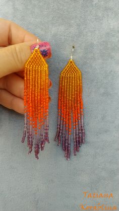 These unique handmade earrings are made of high-quality Czech beads and strong synthetic thread. They are elegant, fashionable, and highly versatile, suitable for everyday wear. Color: orange, purple . There may be some color discrepancies which is due to the different monitor settings I will make these earrings for you in your favorite size. 100% hand made with love! Measurements: Length-about 10,5cm (4.13 inch) Width -about 2 cm (0.79 inch) Materials: Sterling silver components Czech glass bea Handmade Purple Tassel Earrings With Round Beads, Orange Handwoven Dangle Beaded Earrings, Handmade Purple Tassel Earrings, Handwoven Orange Beaded Earrings For Gift, Handwoven Orange Beaded Earrings As Gift, Handmade Orange Tassel Earrings For Summer, Handmade Purple Dangle Tassel Earrings, Orange Handwoven Beaded Earrings, Beaded Orange Tassel Earrings As Gift