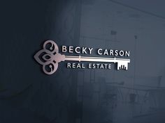 the logo for becky caron real estate, which is located in an office building