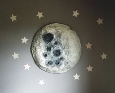 a moon and stars wall sticker in a child's room with grey walls