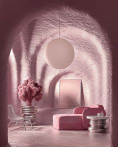 a room with pink walls and furniture in the center, as well as a round light fixture