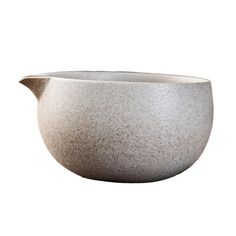 a white bowl with a handle on the side