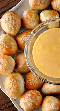 a plate topped with rolls and dipping sauce