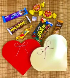 a heart shaped box with candy and candies