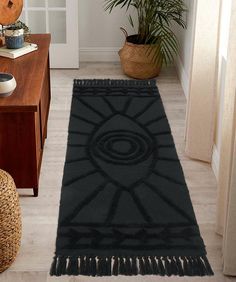 a black rug with fringes on the floor