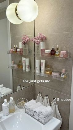 a bathroom sink sitting under a mirror next to a shelf filled with personal care items