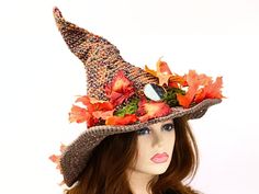 Ready for the Renfaire, a festival, cosplay, a pagan celebration, your table centerpiece, or just plain fun, this witch or wizard hat is covered in gloriously detailed Fall leaves, with moss running through them all the way around the hat. A stone symbol of balance serves as the talisman. The brim is wired and I gave it an open stitch for extra ventilation and a rustic feel. I made this in a blend of cotton and hand-dyed merino so you can wear it year round. The way I stitch allows you to twist Brimmed Costume Hats For Halloween Themed Events, Brimmed Costume Hats And Headpieces For Halloween, Fantasy Style Costume Hats For Carnival, Halloween Fantasy Brimmed Costume Hat, Wide Brim Halloween Costume Hats And Headpieces, Witchy Adjustable Costume Accessories For Festival, Witchy Festival Costume Accessories, Themed Halloween Festival Costume Hats And Headpieces, Themed Costume Hats And Headpieces For Halloween