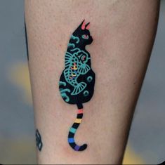 a colorful cat tattoo on the leg