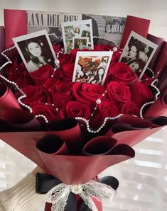 a bouquet of red roses with pictures and pearls